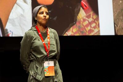 A woman presenting on stage