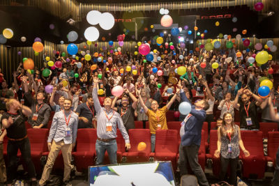 Audience members throwing balloons