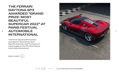 A picture of a red Ferrari sports car on the right with text on the left of the website’s landing page which uses a little circular indicator at the bottom of the page