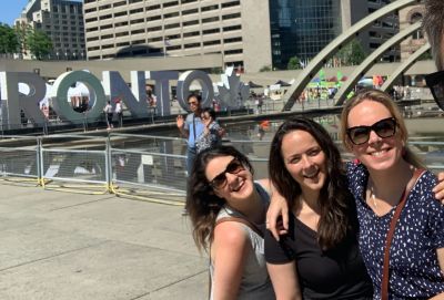 The team in front of the Toronto sign