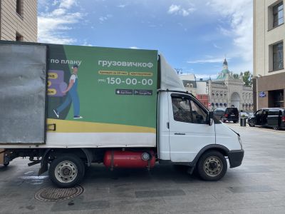 A van with an advertisement written in Cyrillic script