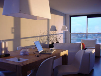 A picture of a beautiful living room with a computer opened on the dinner table.