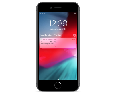 iPhone 8 Plus lock screen shown with a grouped notification stack from Notification Tester app.