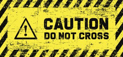 A sign with the text CAUTION Do Not Cross