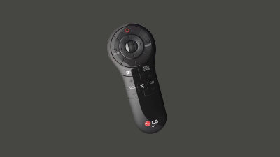 A black LG Magic Remote with a circular D-pad at the top, surrounded by navigation and function buttons. Unlike traditional rectangular remotes, this one has a sleek, tapered oval design that widens at the top and narrows towards the bottom, making it comfortable to hold. This remote supports motion controls, allowing users to point, gesture, and interact with the TV using an on-screen cursor.