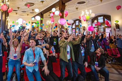 Conference attendees throwing balloons