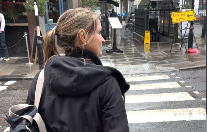 Vicki following the clues across a rainy Soho street
