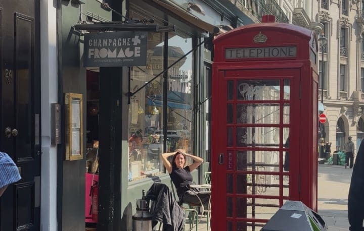 The Champagne + Fromage shopfront in Covent Garden, beside a red telephone box