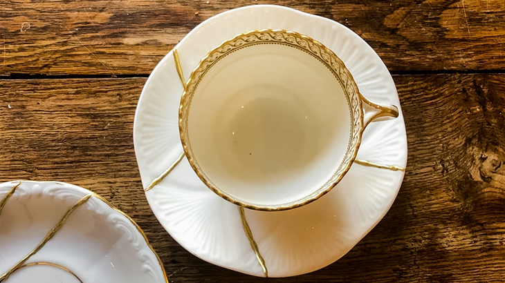 Cup and saucer flat lay beautifully repaired with gold Kintsugi method