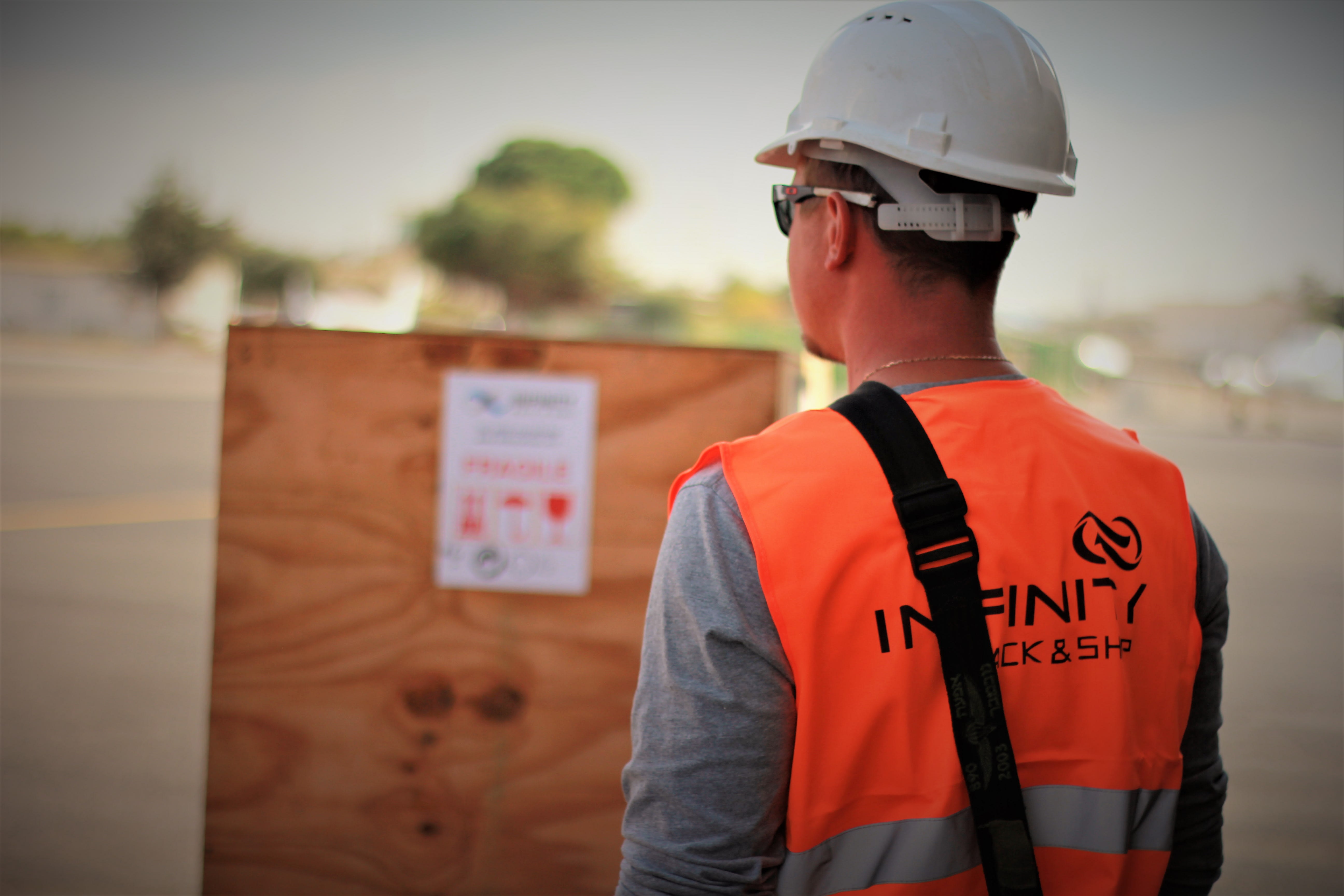 A large, custom-crated machine successfully loaded and ready for international shipping, showcasing a successful project result by Infinity Pack & Ship.