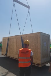 A specialist from Infinity Pack & Ship carefully wrapping a delicate piece of fine art for secure international shipping.