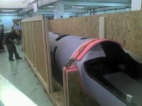 An Infinity Pack & Ship expert securing a valuable antique piece of furniture inside a custom, foam-lined crate for maximum protection.