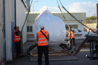 The Infinity Pack & Ship expert rigging team on-site, working together to safely guide a heavy machine into its final position.