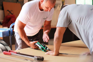 A close-up of a high-value electronic component being carefully packed with anti-static materials, showing Infinity Pack & Ship's meticulous process.