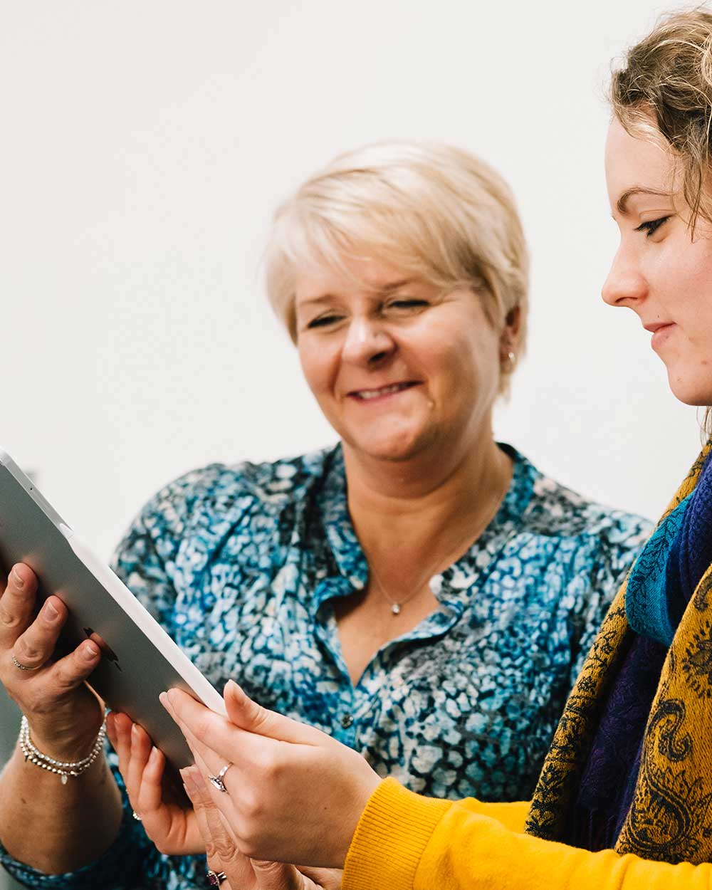 Hiring team selecting candidates on a tablet
