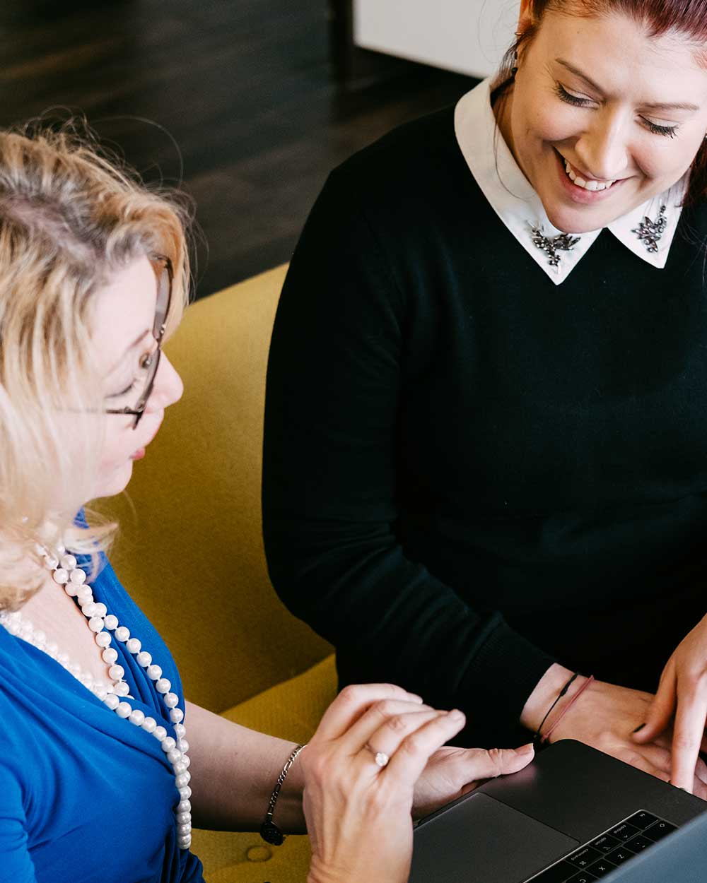 Recruiters reviewing talent pool on laptop