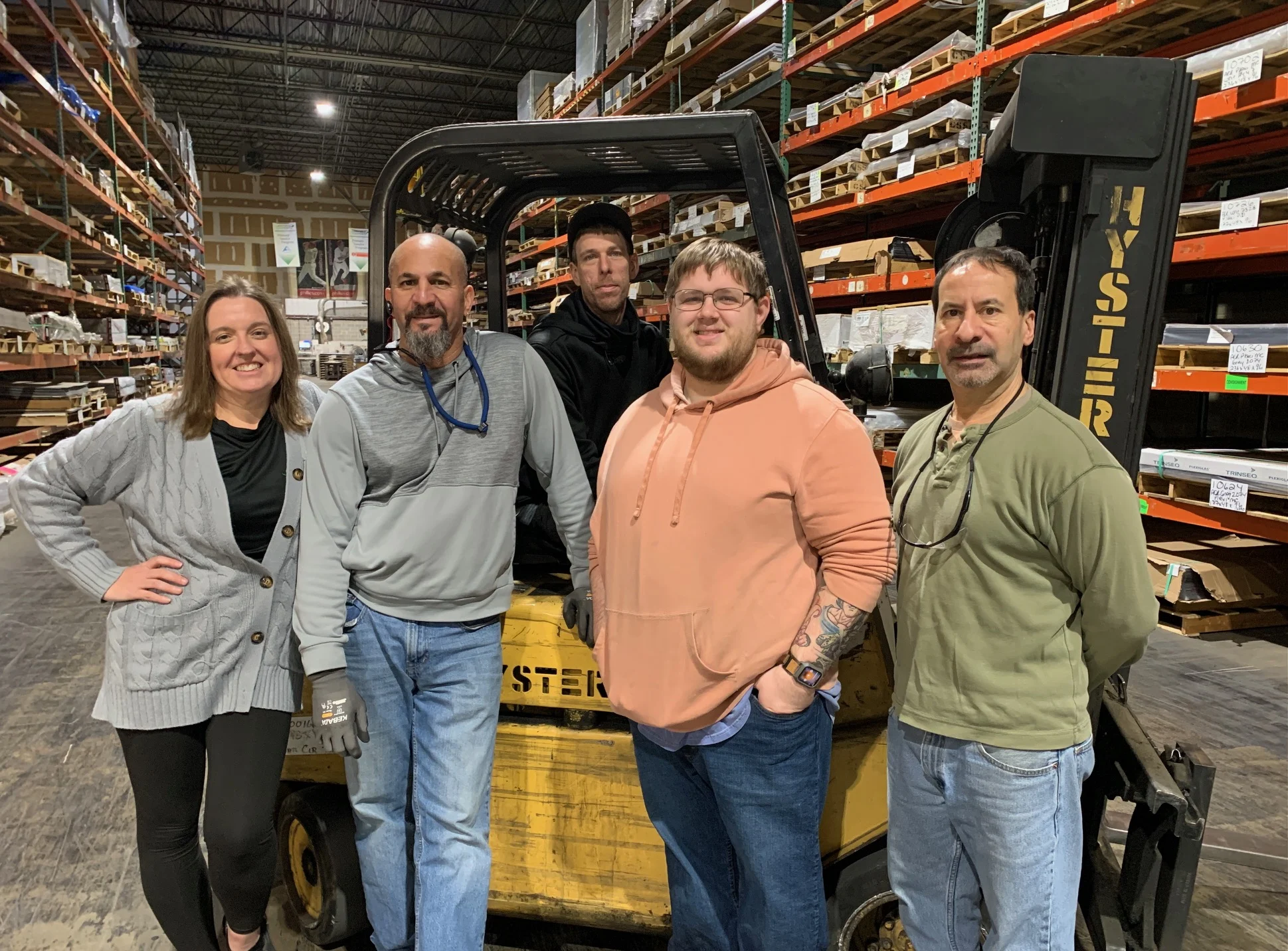 Warehouse and operations team handling plastic sheets, rods, and tubes for Philadelphia-area orders