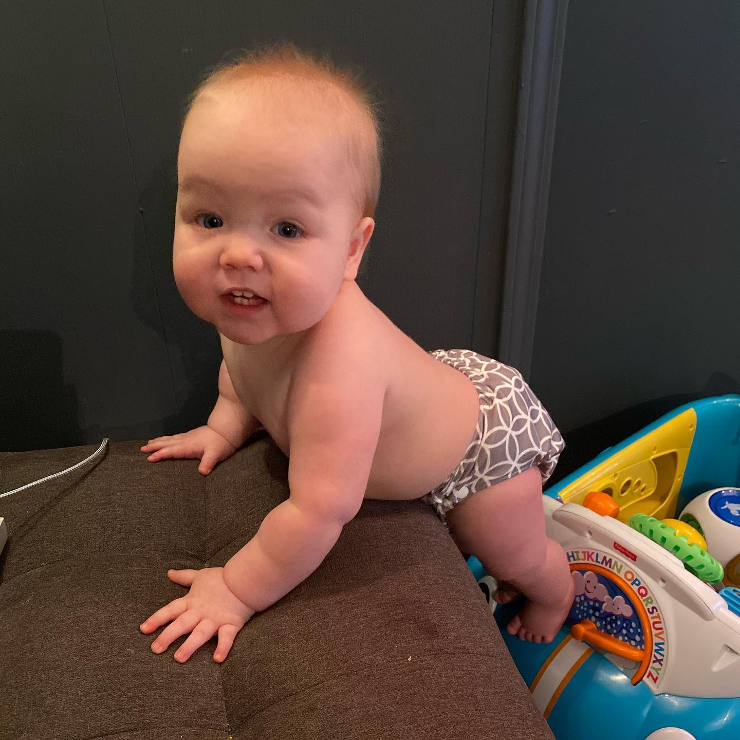 Climbing on toys to get to daddy's electronics. 👀