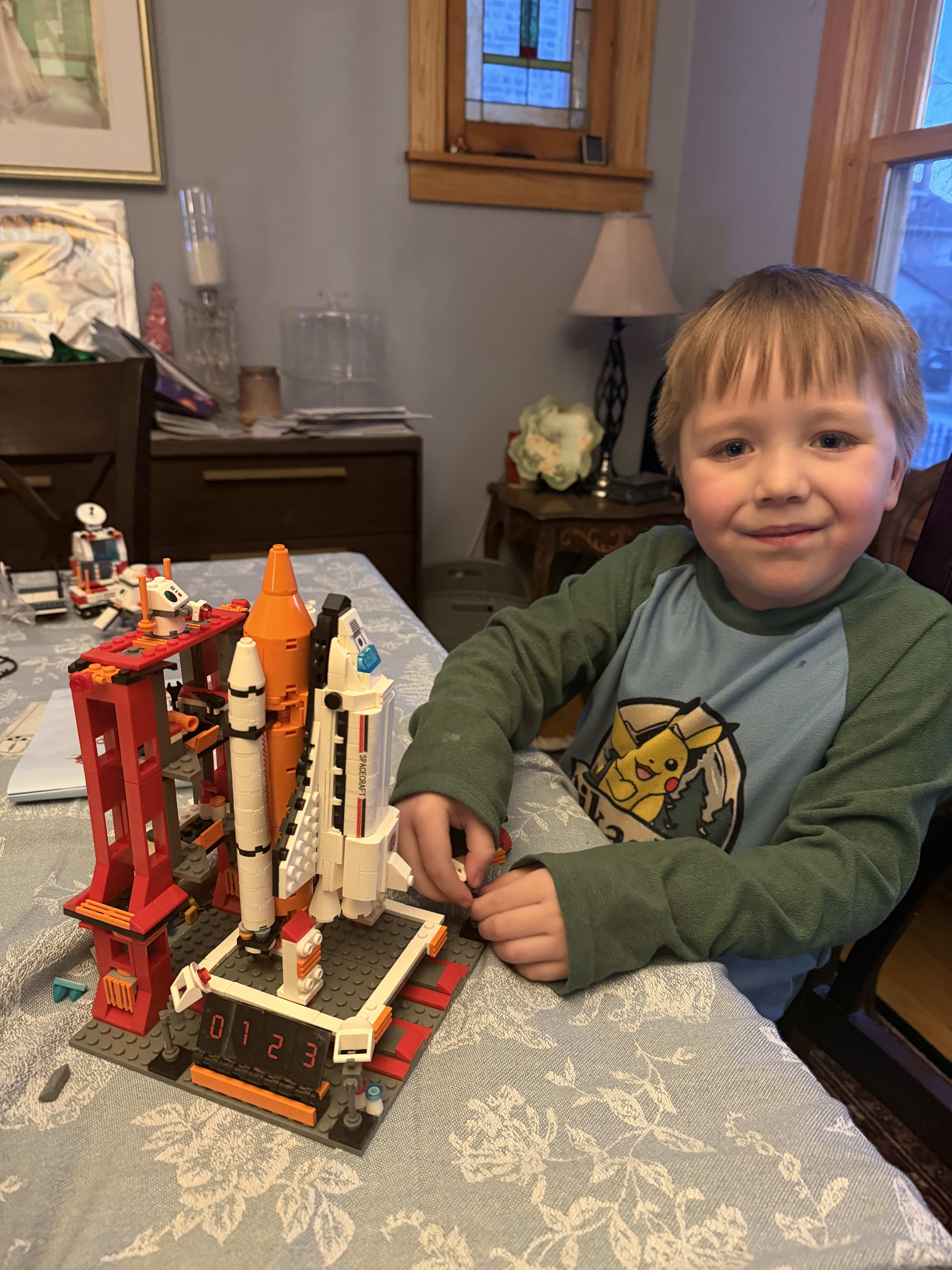 Ryan shows off his off-brand Lego space shuttle build.