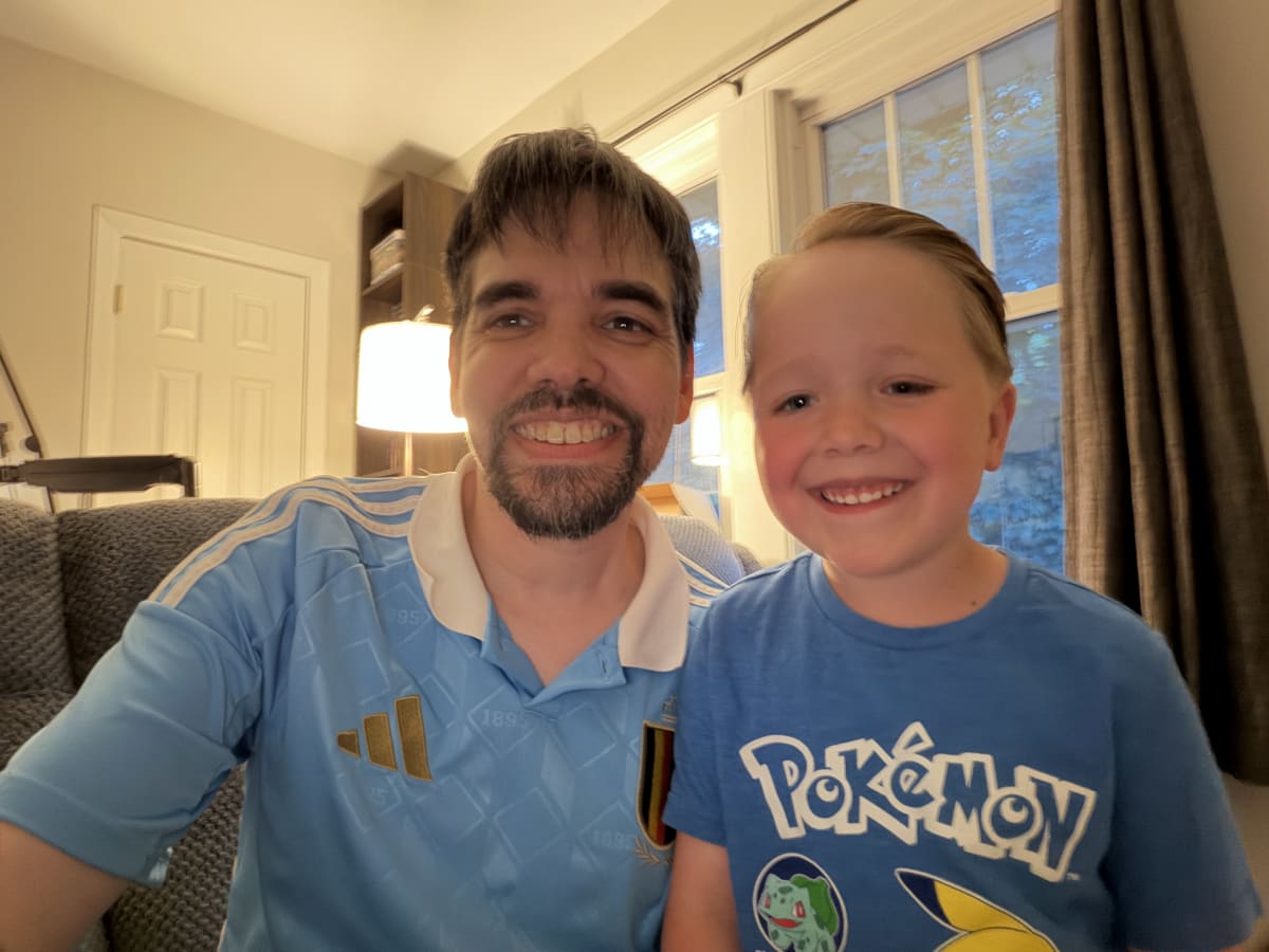 Mike with his bangs covering his forehead and Ryan with his hair combed back and parted to the side.