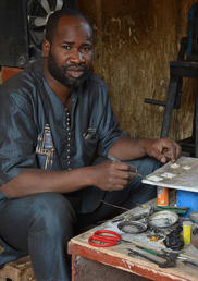 A man at his workshop with tools.