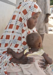 A side view of Habiba with her child.