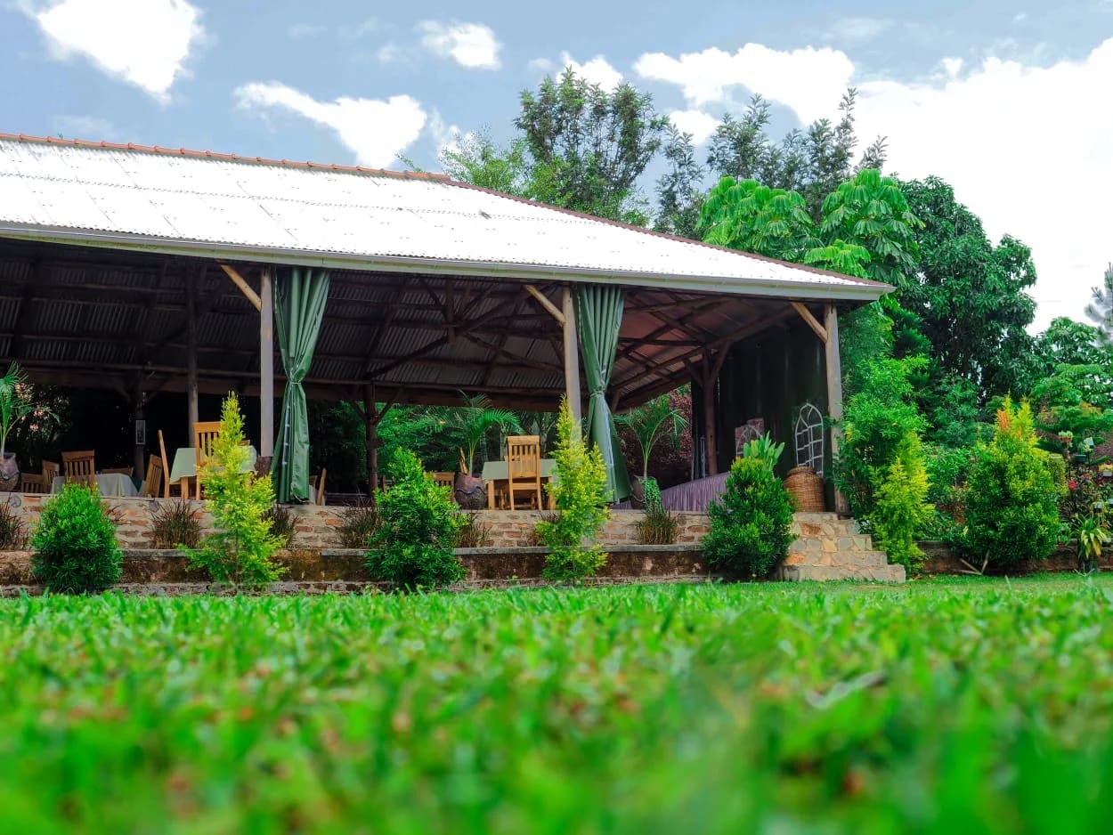 Open pavilion overlooking a neatly cut lawn and trees