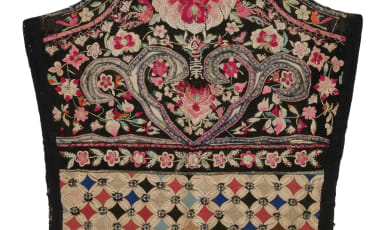 Baby Carrier photo showing an embroidered baby carrier from Southeast Asia. 