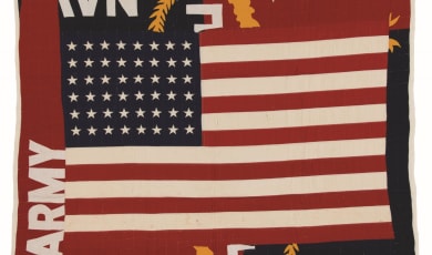 Flag Quilt photo showing an American flag with army and navy printed in the margins. 