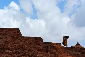 monk taking photo in Sri Lankan historic site