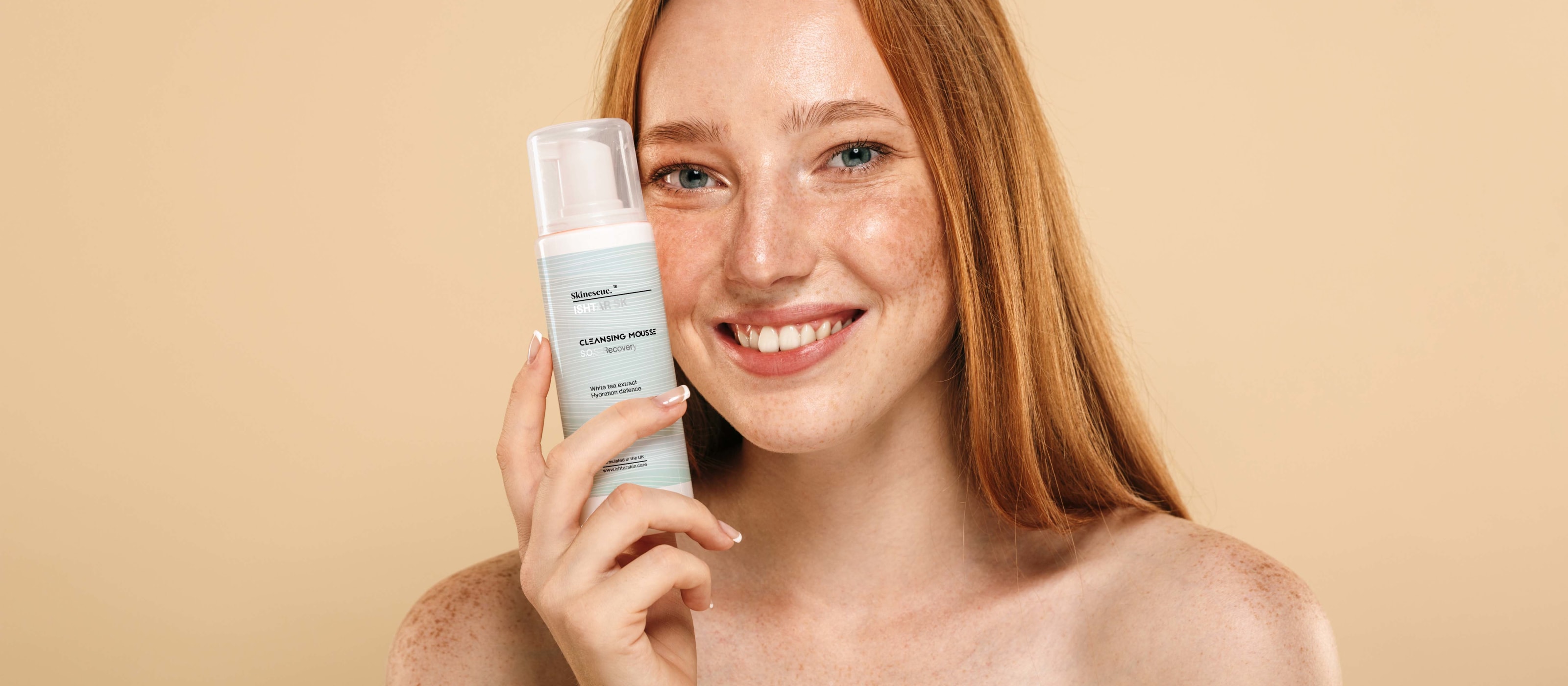 Model holding White Tea Cleansing Mousse