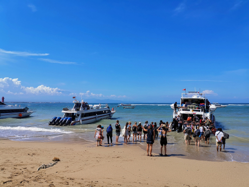 Tourist embarking fast boat to Nusa Penida from Sanur beach
