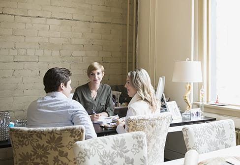 a young couple meeting with a counselor