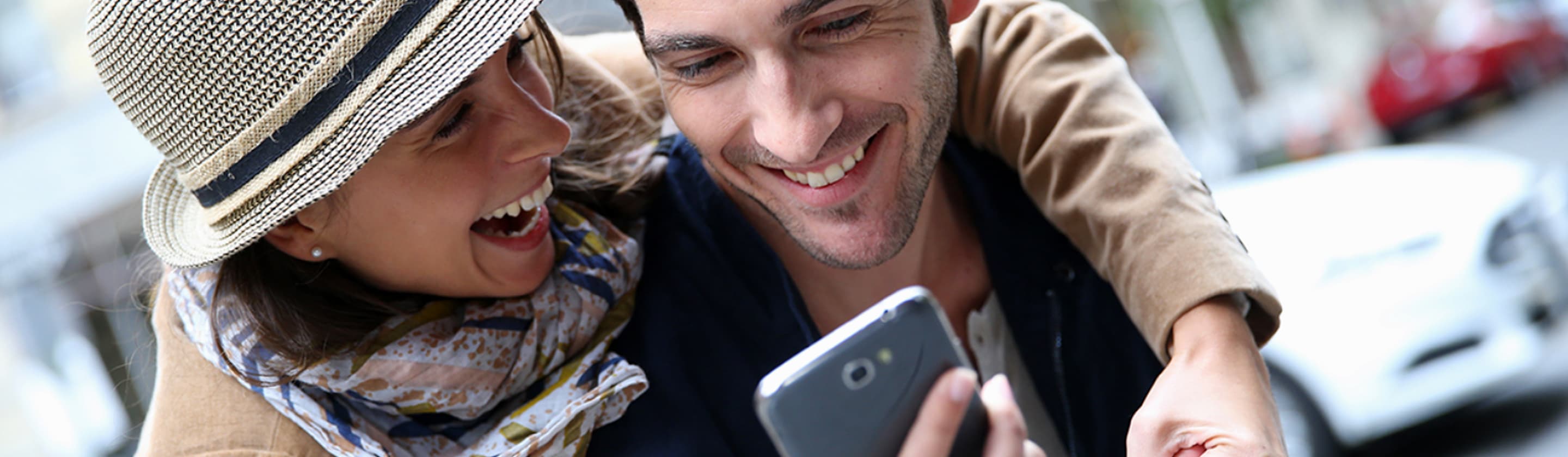 smiling couple with mobile phone