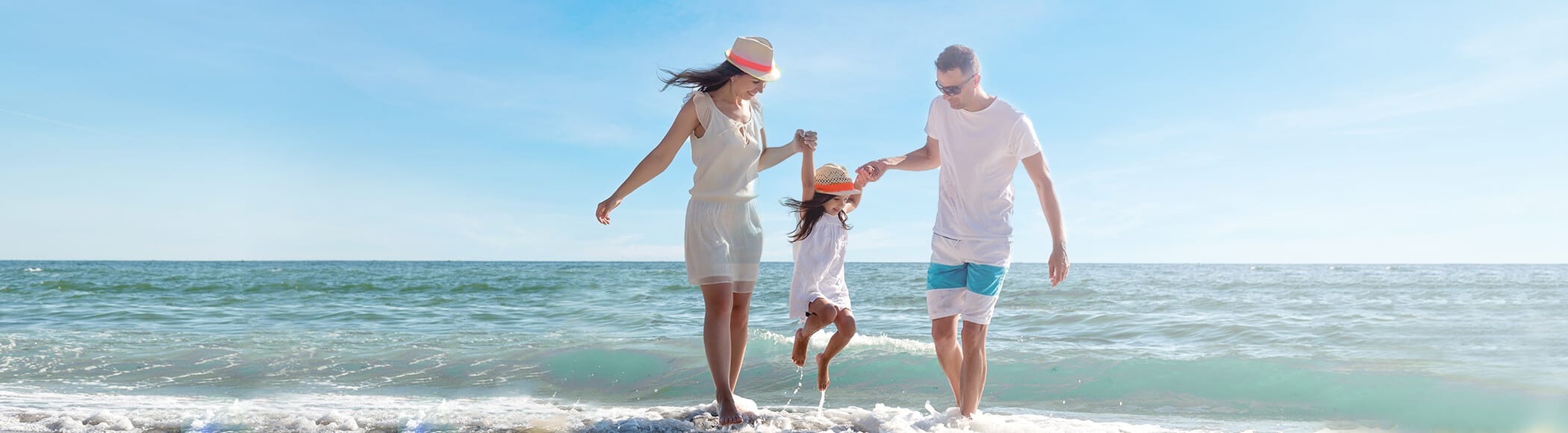 The image shows a family enjoying their time on a beach.