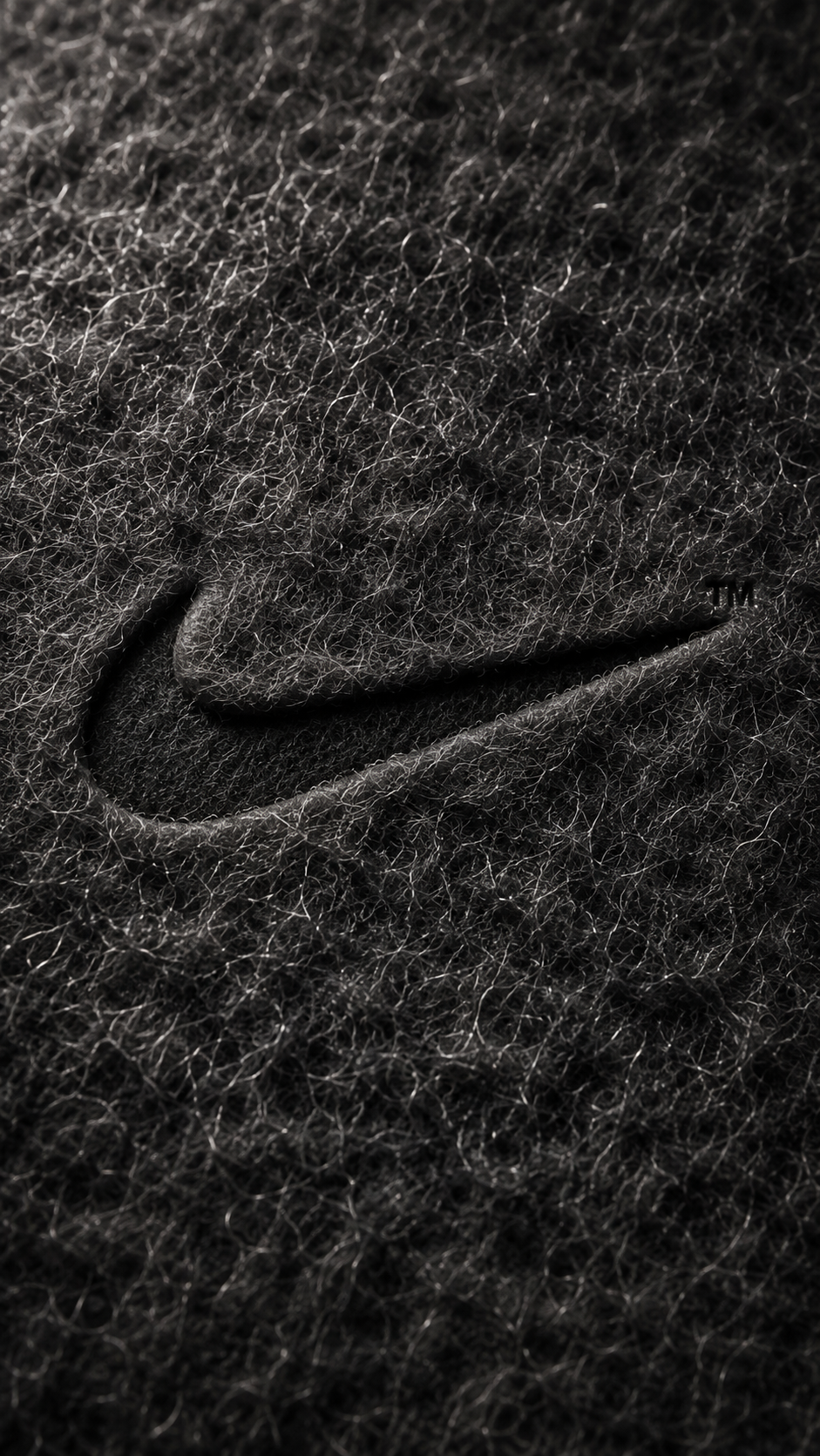 Nike Swoosh Debossed on Black Macro Fibrous Surface — Image 2 (9:16)