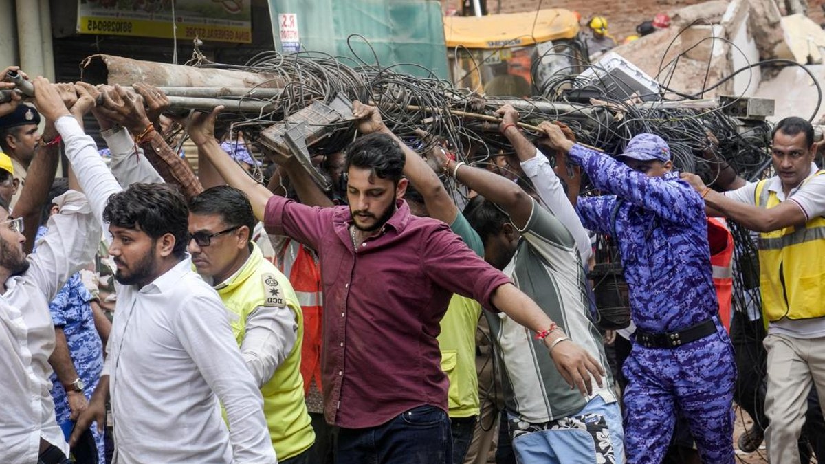 Students help clear debris after Satya Niketan collapse - building collapse