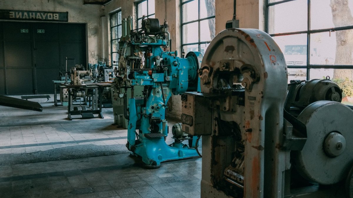 AI and Robots to Reshape Africa's Textile Industry Interior of an old factory showcasing vintage machines and equipment.
