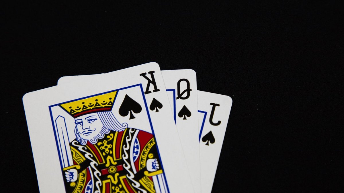 Non-profit Launches Inclusive Digital Birthday Cards Close-up of Jack, Queen, King of Spades playing cards on black background.