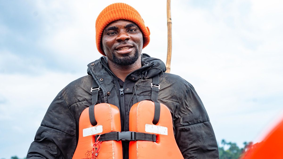 ARIZA Showcases Carbon Monoxide Alarms in Dubai A man wearing a life jacket with an orange beanie smiles confidently outdoors.