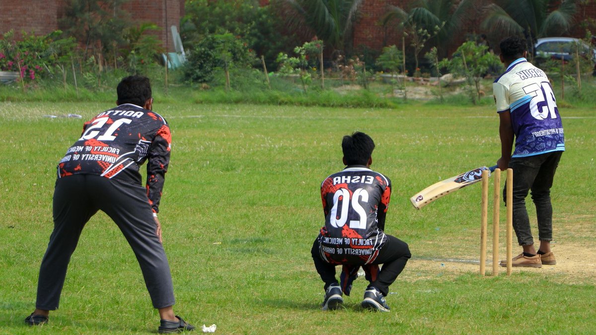Tennis Ball Cricket Leagues Rise as Smartphones Face Repair Challenges Cricket players in action on a sunny day at an outdoor field.