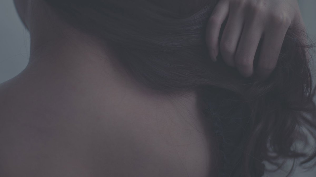 Fall 2026 TestTube Arrives with Seasonal Skincare Picks Artistic close-up of a woman gently touching her hair, capturing soft textures and intimate mood.