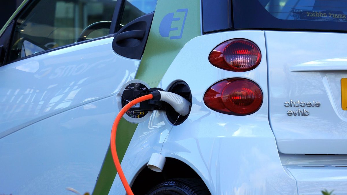 Indonesia road test reveals DFSK E5 Plus strengths and quirks Close-up of an electric car being charged, highlighting eco-friendly transportation.