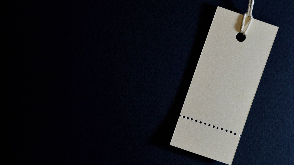 Elegant minimalist card with a string, ideal for labeling or pricing against a black background.