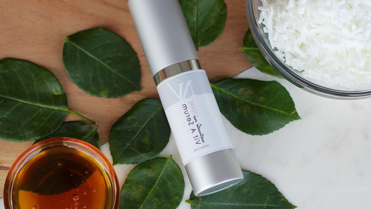 Olay Introduces New Body-Care Products for Glowing Skin Top view of a natural vitamin A serum with honey, coconut, and leaves.