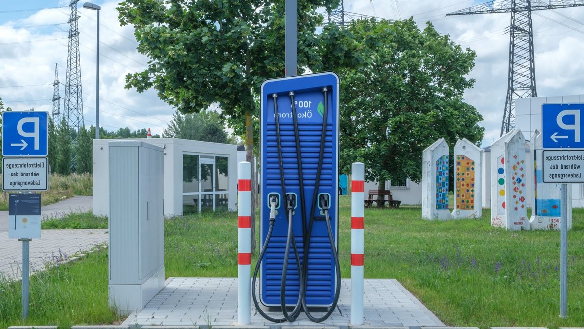 BMW unveils affordable electric compact car for 2028 Public charging station with eco-friendly design for electric vehicles.