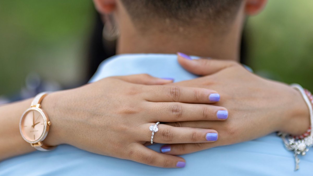 Schneider Electric HR chief urges proactive leader development Close-up of a romantic embrace showcasing a stunning engagement ring and bracelet.