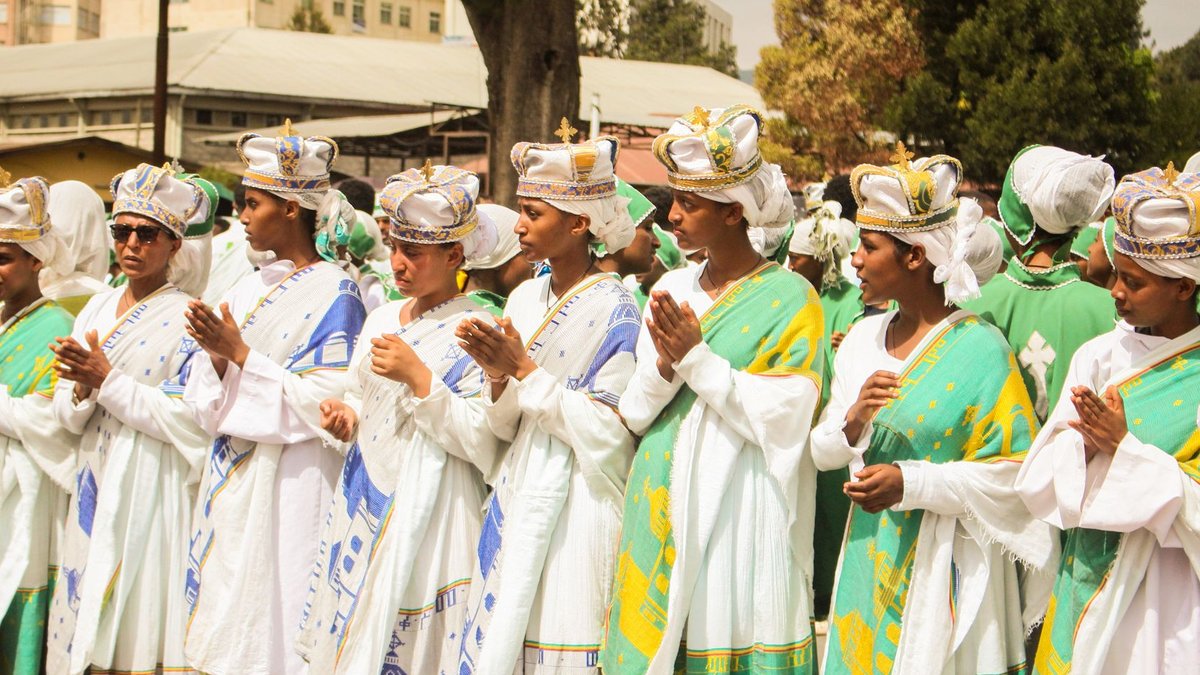 A vibrant religious ceremony with people in traditional Ethiopian attire, Addis Ababa, Ethiopia.