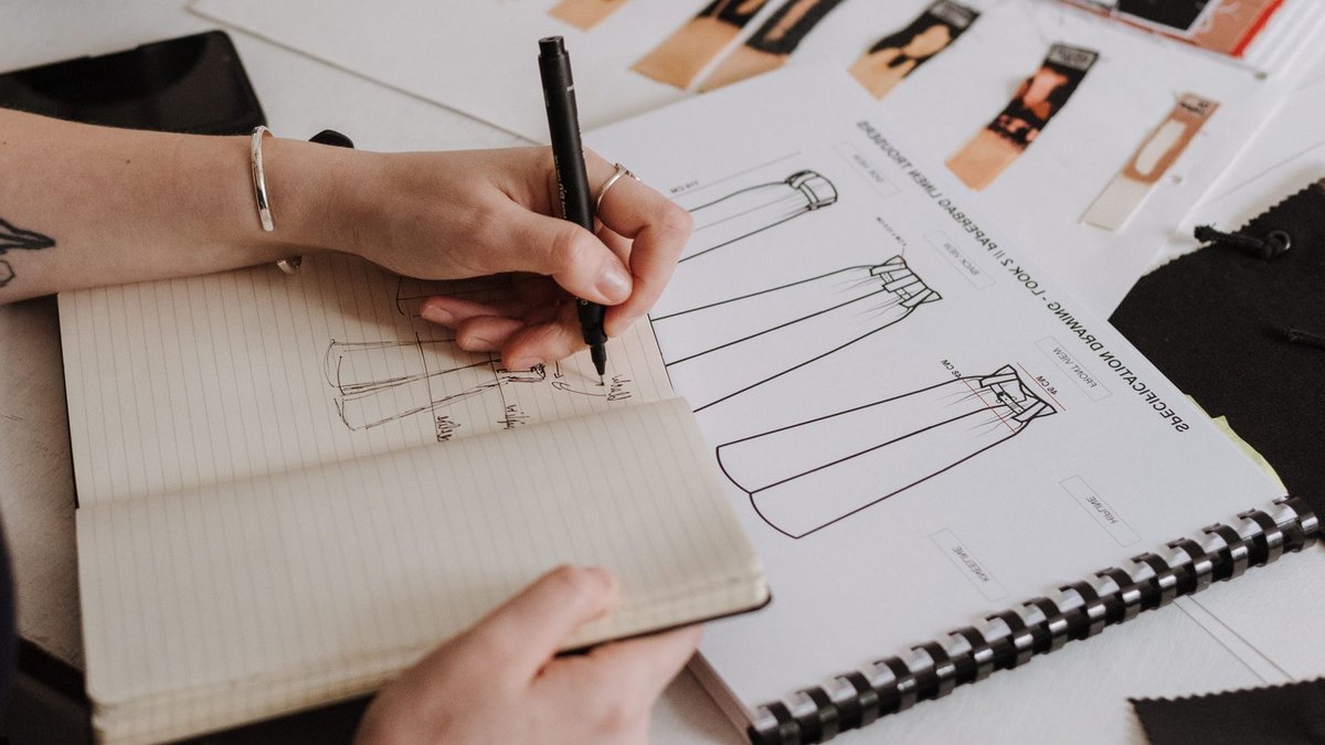 Victoria Beckham Launches First Homeware Line with Westwing Unrecognizable tattooed female designer drawing sketches of new collection in notebook while sitting at table with sketchbook