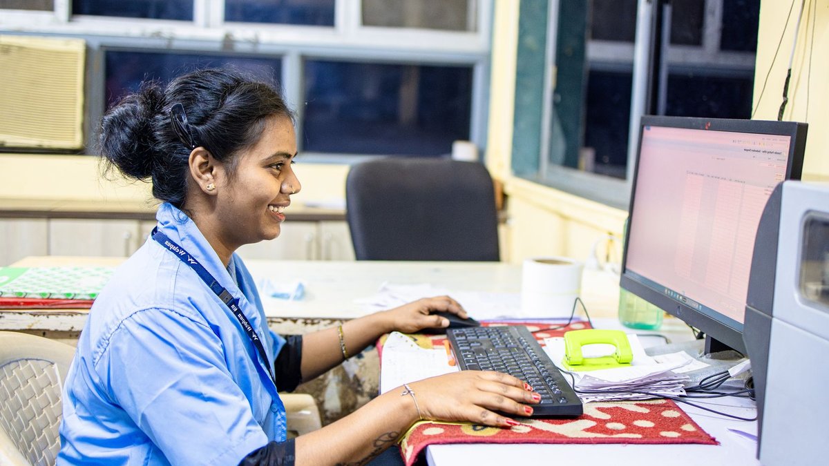 Getty Images Seeks Bankruptcy Protection Amid AI Disruption Smiling woman working on a desktop computer in a bright office setting.